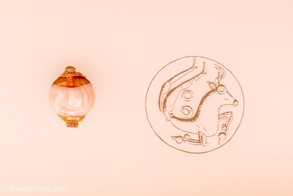 A piece of jewelry engraved with the Minotaur depiction.