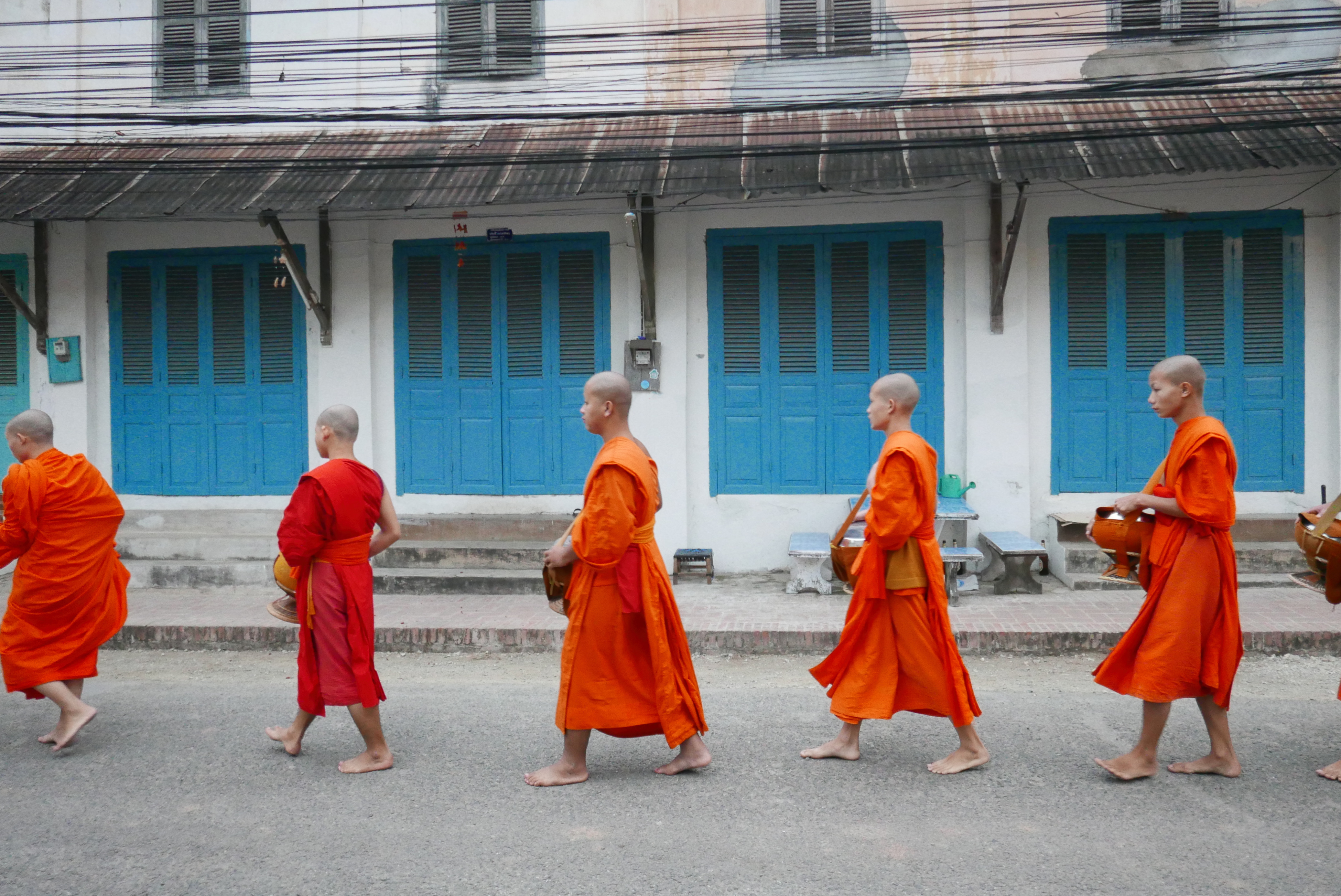 Monks passing by the colonial house