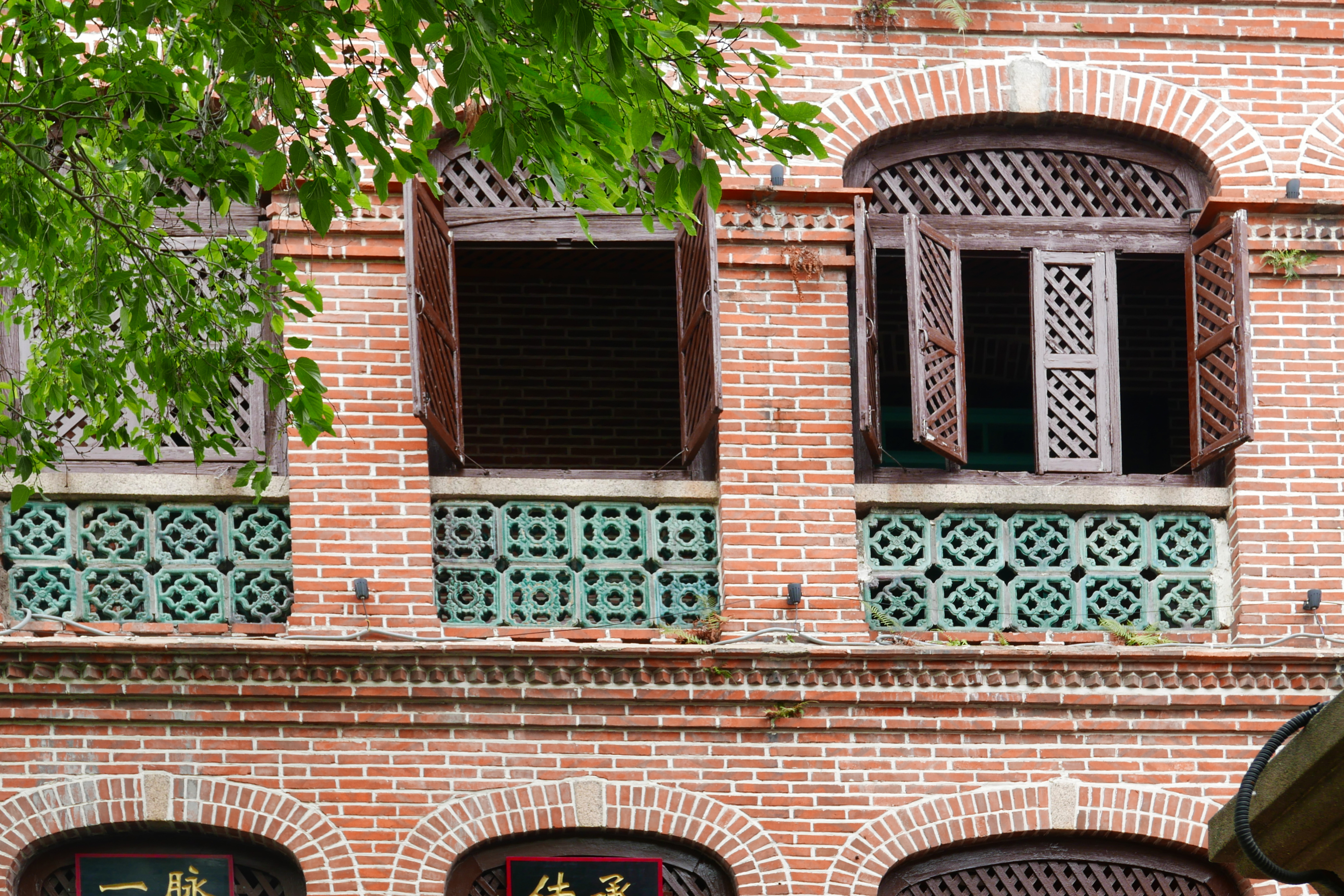 French shutters on red brick walls